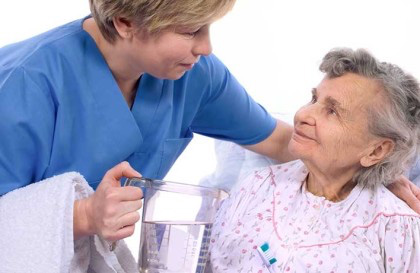 A nurse assisting a olderly patient